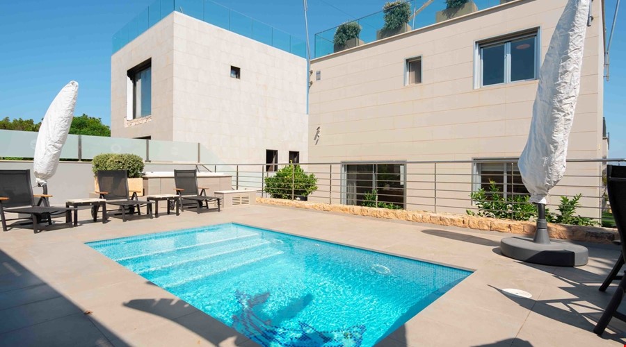 Elevated sea view townhouse with rooftop solarium & pool for sale in cala blava